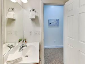 a white bathroom with a sink and a mirror at Cassiopeia in McHenry +32 photos