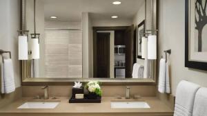 a bathroom with two sinks and a large mirror at Spring Break! Luxurious Ski-In · Ski-Out Resort! in Truckee
