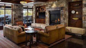 a living room with two couches and a fireplace at Spring Break! Luxurious Ski-In · Ski-Out Resort! in Truckee