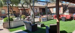 a patio with grass and chairs in front of a house at El Amador Downtown Luxury Inn in Tucson