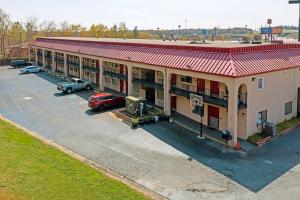 an aerial view of a hotel with a parking lot at Regency Inn & Suites in Macon