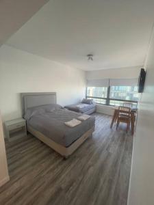 a bedroom with a bed and a table and a chair at Centro Porteño in Buenos Aires