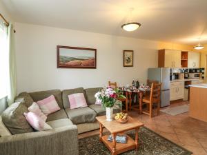a living room with a couch and a table at Kingfisher Cottage in North Molton