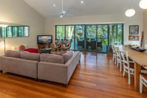 a living room with a couch and a table at A Yarraangunthi in Smiths Lake