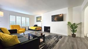 a living room with a couch and a fireplace at Double Suite Santa Monica - Free Parking in Santa Monica