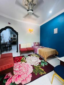 a bedroom with a bed and a blue wall at Rerama Homestay Langkawi 5 minutes driving to Chenang Beach, kitchen, Wifi, parking, village vibes in Pantai Cenang