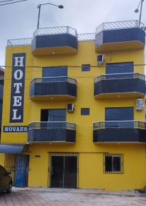 a yellow building with balconies on the side of it at HOTEL NOVAES in Castanhal