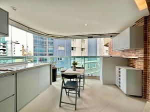 a kitchen with a table and chairs in a building at Estanconfor 702 in Santos