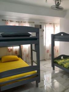 a bedroom with two bunk beds in a room at Jirah’s inn in Legazpi