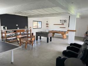 a living room with ping pong tables and chairs at Picasso in Praia
