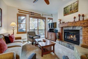 a living room with a couch and a fireplace at Lodge at Brookside in Avon