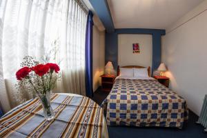 Postel nebo postele na pokoji v ubytování Hotel T'ika