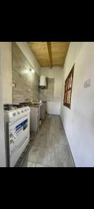 an empty kitchen with a stove and a window at Cabañas Viltez 2 in Tafí del Valle
