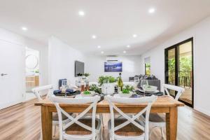 a dining room with a table and chairs at Ocean Haze - Beach house in Agnes Water in Agnes Water