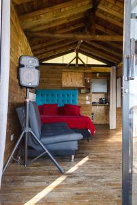 a bedroom with a bed and a tv in a room at Cabaña San Angel in La Ceja