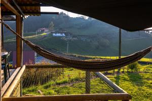 a hammock on a balcony with a view of a mountain at Cabaña San Angel in La Ceja