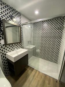 a bathroom with a sink and a shower at Hotel Tierra Marina Centro Historico in Mazatlán