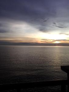 a sunset over a large body of water at PD Corus myHoliday Homes & Apartments in Port Dickson