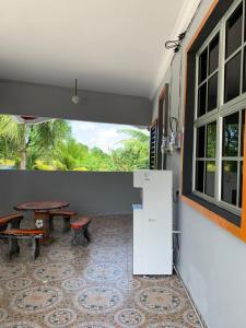 a room with a table and a table and a window at Rerama Homestay Langkawi 5 minutes driving to Chenang Beach, kitchen, Wifi, parking, village vibes in Pantai Cenang