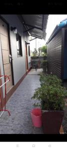 a patio with potted plants and a building at Chill land house in Bang Tao Beach