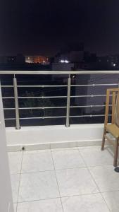 a chair sitting on top of a balcony at night at Best Residence in Nouakchott