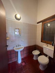 a bathroom with a sink and a toilet at La Ramada in Tafí del Valle