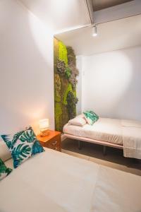 Postel nebo postele na pokoji v ubytování Banana Beach Patacona Rooms