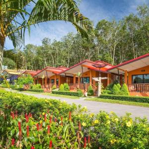 a row of houses with red roofs and flowers at Infinite Resort and Cafe in Krabi town