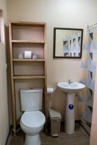 a bathroom with a toilet and a sink at Good Vibes Apartments in Talamanca
