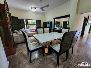 a dining room with a table and chairs and a couch at Finca Villa Lili in Santa Fe de Antioquia