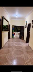 a living room with a tile floor and a hallway at Finca Villa Lili in Santa Fe de Antioquia