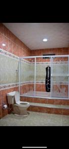 a bathroom with a shower and a toilet in it at Finca Villa Lili in Santa Fe de Antioquia
