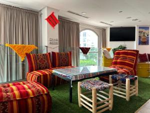 uma sala de estar com um sofá, uma mesa e cadeiras em Lovely Apartment em Tânger