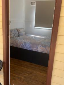 a small bed in a room with a window at Bright Cabin Park in Bright