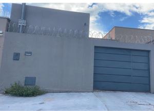 a building with a garage door on the side of it at Casa piscina 3 quartos in Goiânia