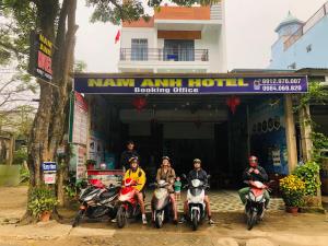 a group of people on motorcycles in front of a hotel at Nam Anh Hotel in Phong Nha