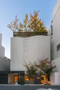 a building with a white facade at Y11 hotel azabu ten in Tokyo