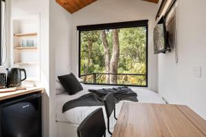 a room with a table and a large window at Bright Cabin Park in Bright