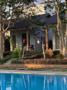 a house with a swimming pool in front of it at Her Garden Home in Phu Quoc