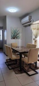 a dining room with a table and chairs at Modern 2BR Condo with Fiber Net in Davao City