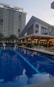 a large swimming pool in front of a building at Modern 2BR Condo with Fiber Net in Davao City