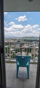 a blue bench sitting on top of a balcony at Modern 2BR Condo with Fiber Net in Davao City