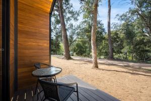 a patio with two chairs and a table on a porch at Bright Cabin Park in Bright