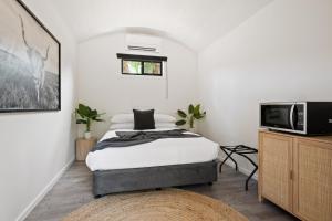 a bedroom with a bed and a tv at Bright Cabin Park in Bright