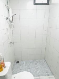 a white bathroom with a toilet and a sink at Imperio Homestay Alor Star in Alor Setar