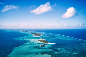 an aerial view of two islands in the ocean at Jawakara Islands Maldives in Lhaviyani Atoll
