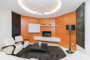 a living room with a couch and a tv at Tanjung Bungah 5BR 18 Bungalow KTV in Tanjung Bungah