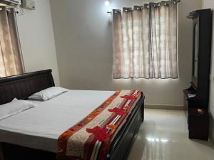 A bed or beds in a room at 2 BHK Apartment at Gachibowli