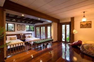 a large living room with a couch and a bed at Lanna Charm 5BR Villa in Maerim in Mae Rim
