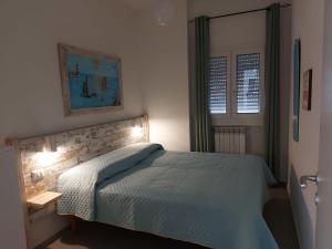 - une chambre avec un lit et une couette bleue dans l'établissement L'Oasi di Giulia, à Olbia